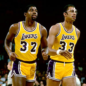 LOS ANGELES - 1987: Magic Johnson #32 and Kareem Abdul Jabbar #33 of the Los Angeles Lakers walk off the court during the NBA game against the New Jersey Nets at the Forum in Los Angeles, California. NOTE TO USER: User expressly acknowledges and agrees that, by downloading and or using this photograph, User is consenting to the terms and conditions of the Getty Images License Agreement. Mandatory Copyright Notice: Copyright 1987 NBAE (Photo by Andrew D. Bernstein/NBAE via Getty Images)